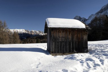 dolomites snow panorama wooden hut val badia armentara hill