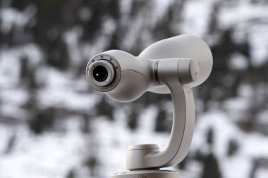 detail of Monocular in winter mountain season dolomites