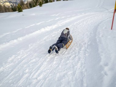 wooden sledge on the snow in winter season in dolomites mountians