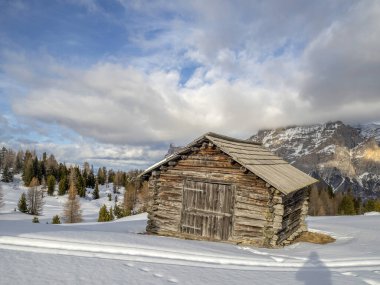 dolomites snow panorama wooden hut val badia armentarola hill