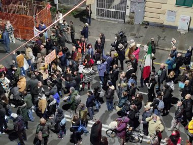 GENOA, ITALY - JANUARY 15 2022 - No green pass no vax protest in city street at night