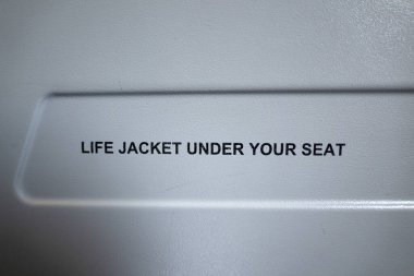 life jacket under your seat airplane sign detail