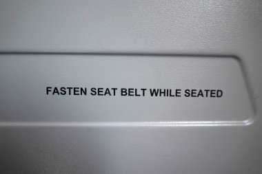 fasten seat belt while seated airplane sign detail
