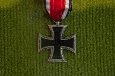 Nazi iron cross old II world war medal on green