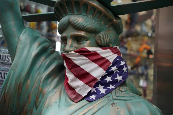 usa flag masked muzzled liberty statue new york city