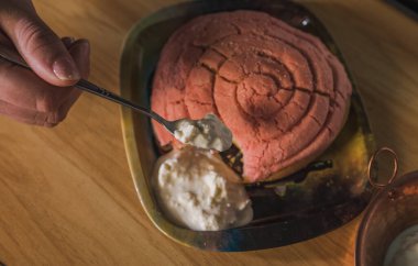 Traditional Mexican sweet bread called conchas, on a basket woven tablecloth.