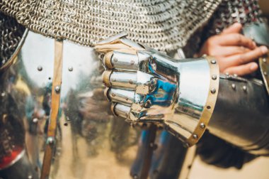 Pitch battle of medieval knights, using metal armor, axes, swords and shields to defend themselves.