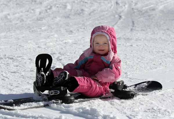 Toddler girl sitting on snowboard — Stock Photo, Image