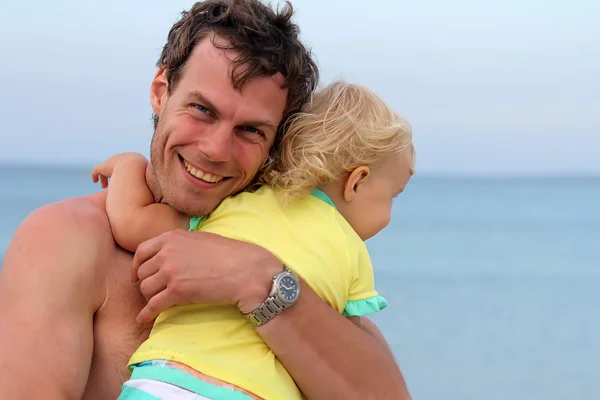 Far och hans dotter på stranden Stockfoto