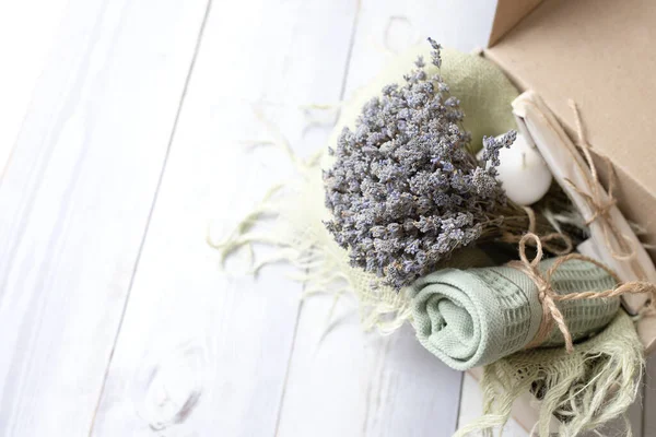 Cotton towel, beautiful lavender bouquet, in a gift box. Organic personal care box, Spa, bath, aromatherapy, delivery, cozy home concept. Nobody. Copy space.