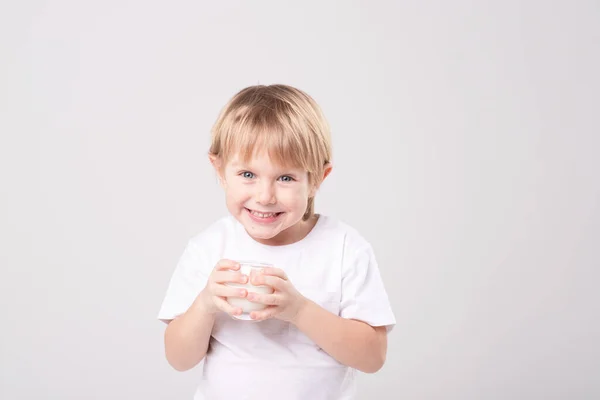 Portrait Blond Child Glass Milk White Background Expressive Face Smile — стоковое фото
