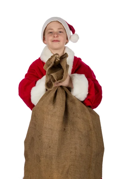 Jongen als Kerstman met zak van giften — Stockfoto