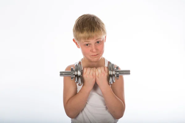 Niño haciendo ejercicio con una mancuerna —  Fotos de Stock