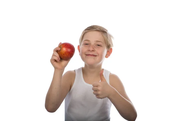 Young boy with a red apple and thumb up — Stock Photo, Image