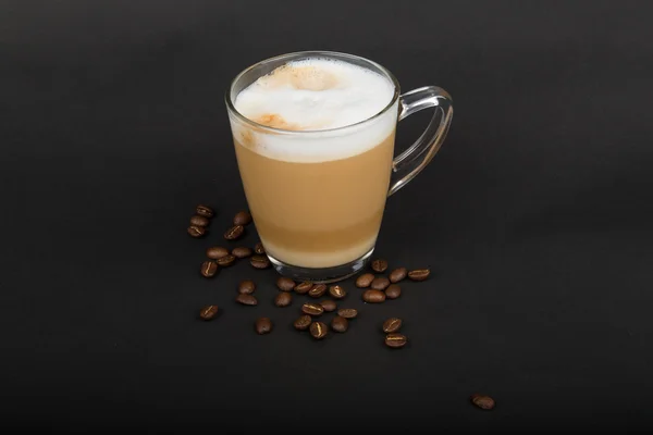 Cappuccino in glass with coffee beans — Stock Photo, Image