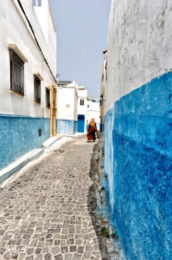 Veiled woman walking in a street of Rabat clipart