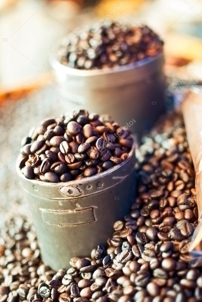 cups of coffee beans in a market
