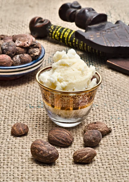 Still life of shea butter ad nuts — Stock Photo, Image