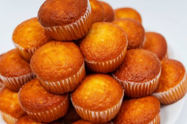 Beyaz arka planda kapkekler. Ev yapımı kekler, yakın çekim bir tabakta..