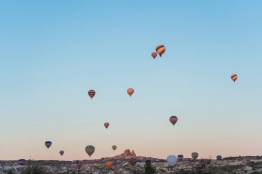 Balloons on the background of a blue sky without clouds. Balloons in the sky in Cappadocia in Turkey. Texture a lot of small air balls flying in the sky