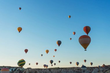 Balloons on the background of a blue sky without clouds. Balloons in the sky in Cappadocia in Turkey. Texture a lot of small air balls flying in the sky