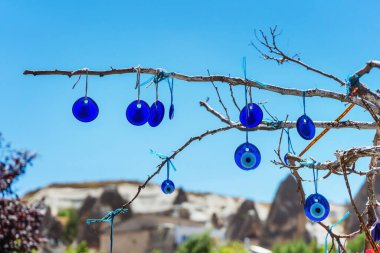 Kapadokya 'daki bir ağacın dallarında mavi gözlü nazar boncukları. Mavi tılsımlı bir ağaç Nazar