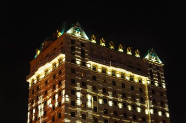 A beautifully illuminated hotel in the city of Batumi. buildings with lanterns on a black background