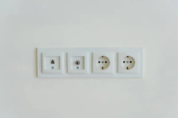 Electric socket on a white background. connection center for Internet television and electrical appliances in the house. white plastic connectors