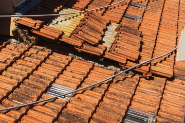 Old tiles on the roof of a house in cyprus. clay orange tiles. ecological roof