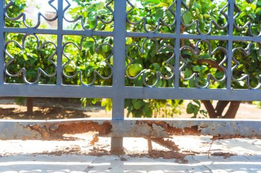 Rotting fences in Cyprus. Metal structures in corrosion. Corrosion of metal on the fence due to salt water