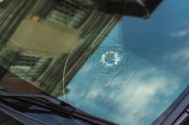 Large crack in the windshield of a car. Stone hitting the windshield of a car. Damaged glass protection of the driver of the transport