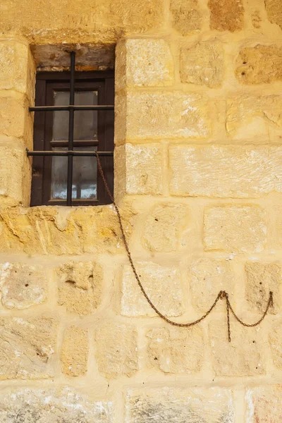 Old iron chain on the wall. metal chain in the interior for tourists