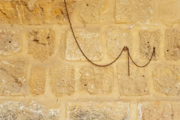 Old iron chain on the wall. metal chain in the interior for tourists