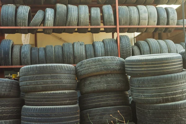 Old car tires under the roof. warehouse of an old tire garage. used car tires