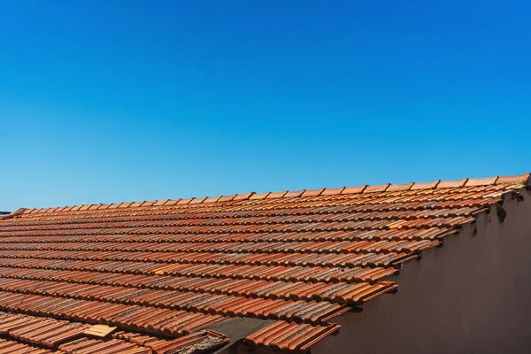 Old tiles on the roof of a house in cyprus. clay orange tiles. ecological roof