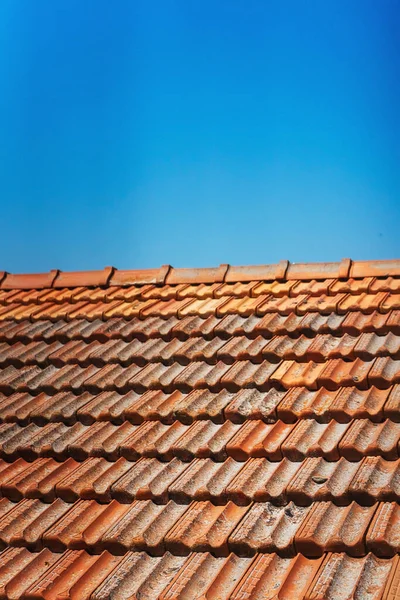 Old tiles on the roof of a house in cyprus. clay orange tiles. ecological roof