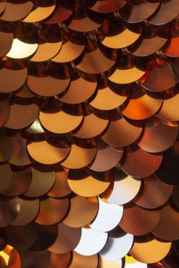 The texture of large sequins on the fabric. gold sequins sewn to the canvas. sequins for belly dancing