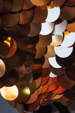 The texture of large sequins on the fabric. gold sequins sewn to the canvas. sequins for belly dancing