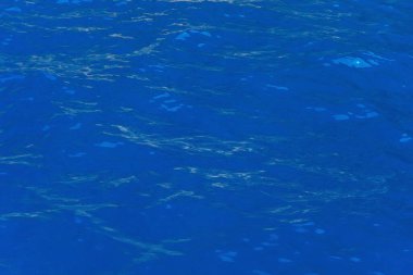 The crystal clean water of the Mediterranean coast. Blue water with a shade of green on the Turkish coast. The texture of the blue sea