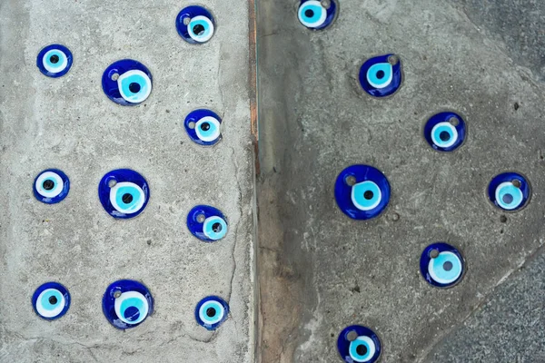 devil\'s eye on the floor near the house. Turkish hallway with blue eyes on the floor. blue eye from damage immured in biton