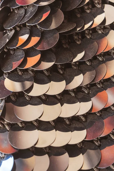 The texture of large sequins on the fabric. gold sequins sewn to the canvas. sequins for belly dancing