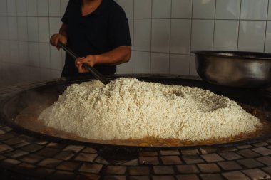 uzbek plov in tashkent. cooking pilaf in the tourist place of uzbekistan