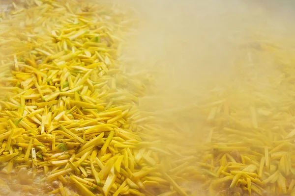 yellow carrots for cooking pilaf in tashkent. finely chopped carrots in an Uzbek cafe. cooking national dish in uzbekistan