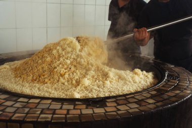 a man cooks uzbek pilaf in a cafe. uzbek cook in pilaf center. preparation of the national Uzbek dish
