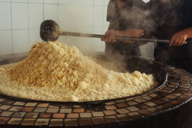 a man cooks uzbek pilaf in a cafe. uzbek cook in pilaf center. preparation of the national Uzbek dish