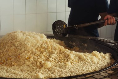 a man cooks uzbek pilaf in a cafe. uzbek cook in pilaf center. preparation of the national Uzbek dish