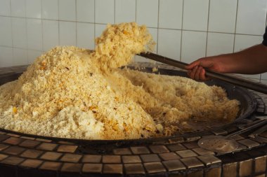 a man cooks uzbek pilaf in a cafe. uzbek cook in pilaf center. preparation of the national Uzbek dish