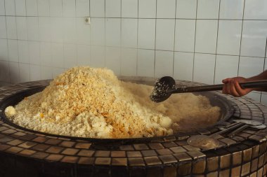 a man cooks uzbek pilaf in a cafe. uzbek cook in pilaf center. preparation of the national Uzbek dish