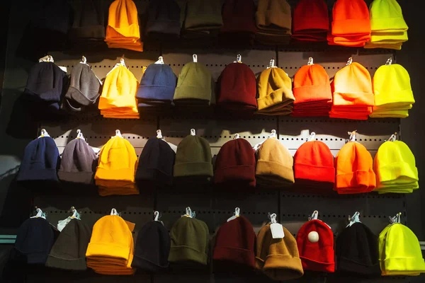 texture of winter hats on the store counter. woolen hats on the market. colorful winter hats