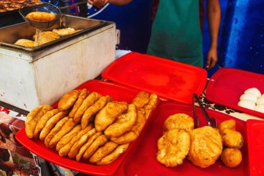 fried dough in the canteen of Tashkent. Deep-fried pies with potatoes at the Uzbek bazaar. national fast food of uzbekistan butter dough with stuffing